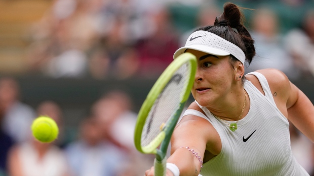 Bianca Andreescu of Canada plays a backhand return to Jasmine Paolini of Italy during their third round match at the Wimbledon tennis championships in London, Friday, July 5, 2024. (AP Photo/Kirsty Wigglesworth)