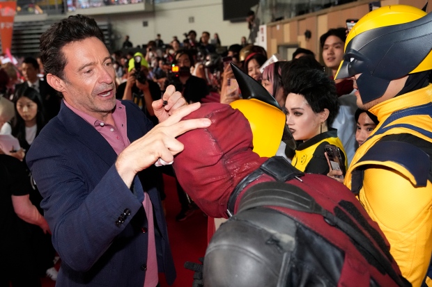 Actor Hugh Jackman signs autographs for fans during the red carpet event to promote his latest movie 'Deadpool & Wolverine' in Seoul, South Korea, Thursday, July 4, 2024. (AP Photo/Ahn young-joon)