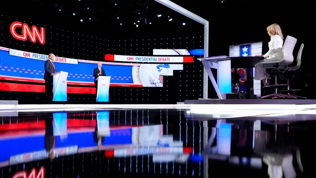 President Joe Biden, on stage at right, and Republican presidential candidate former President Donald Trump, left, participate in a presidential debate hosted by CNN, Thursday, June 27, 2024, in Atlanta. At far right is CNN moderator Dana Bash. (AP Photo/Gerald Herbert)
