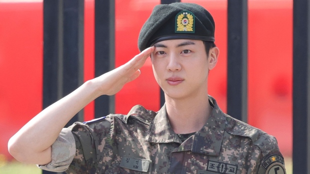 K-pop band BTS's member Jin salutes after being discharged from a mandatory military service outside of an army base in Yeoncheon, South Korea, Wednesday, June 12, 2024. (Im Byung-shik/Yonhap via AP)